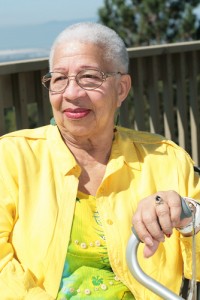 African American senior woman looking into distance and holding her cane