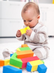Baby playing with colorful blocks