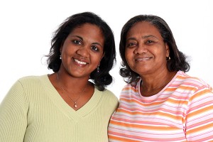 African american mother and daughter smiling, isolated on white background