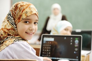 Young girl using a tablet in a school classroom