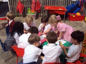 A group of school children working at a table together