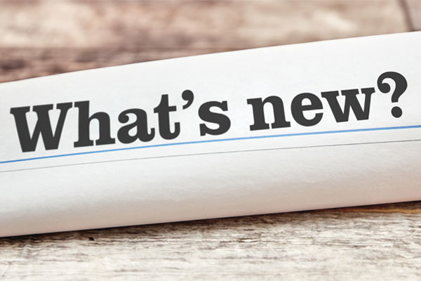 A close-up of a rolled-up newspaper with the text "what's new" written in the center.