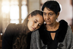 Sad young woman and older woman