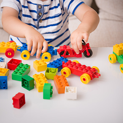 A child playing with a colorful lego train