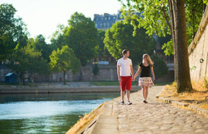 couple walking together by a river