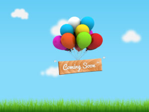 Colorful balloons hold a wooden sign that reads coming soon.