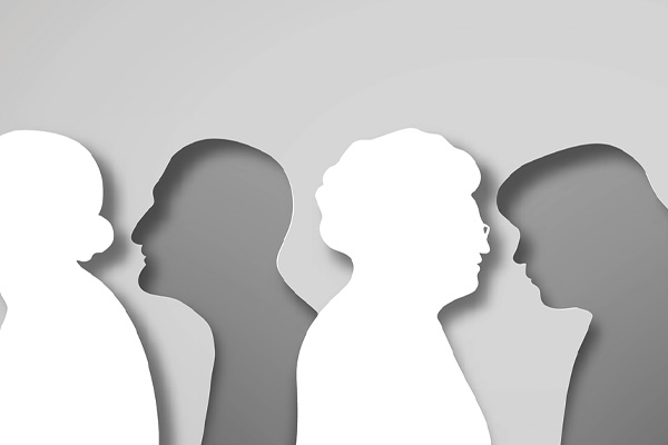 An image of silhouettes of two faces of older people in profile, facing each other. The faces are created by the negative space between two shapes that resemble the profiles of older people.