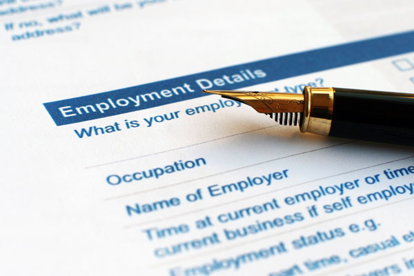 An image of a form titled employment details with a section asking "What is your employment status?" Below that , there are fields for occupation and name of employer. A fountain pen with a gold and black design is placed on the form.