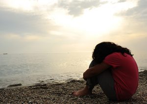 A sad looking girl on a beach